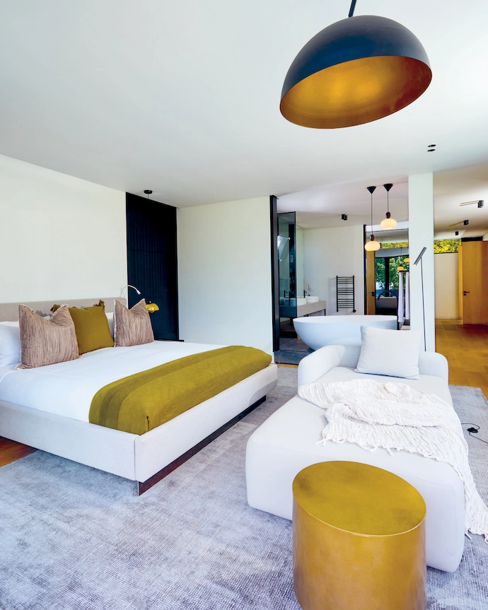 The main bedroom suite is both feminine and masculine, with soft lines and sensual fabrics brushing up against steel, stone and timber.