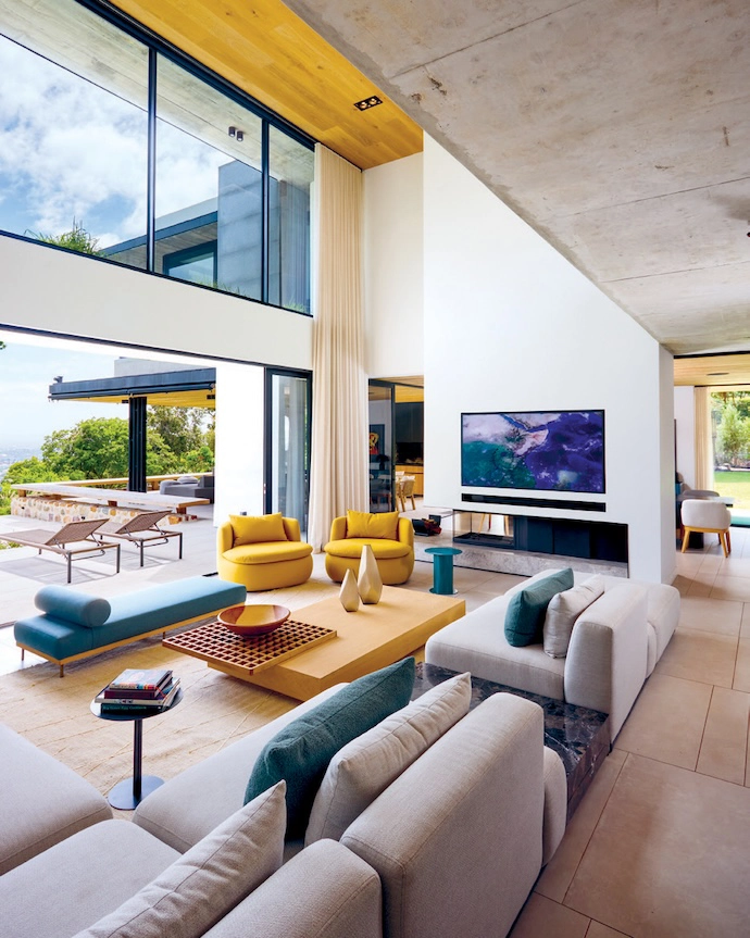 The entertainment area features a collection of versatile bespoke furniture by Hendre to accommodate both large and intimate gatherings.