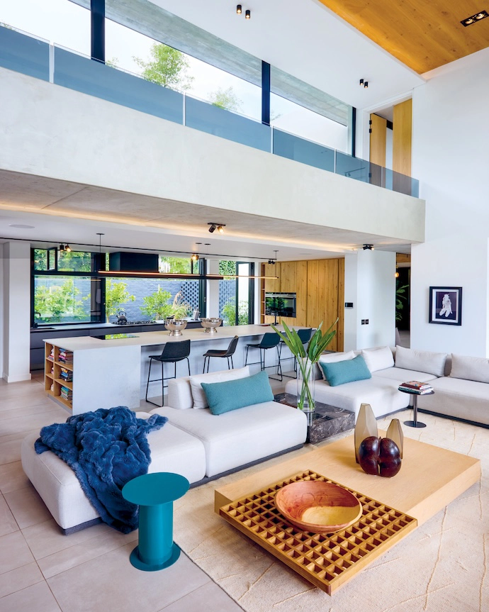 With views out onto a lush courtyard and Table Mountain beyond, the open-plan kitchen benefits from the intimacy of a lowered ceiling.