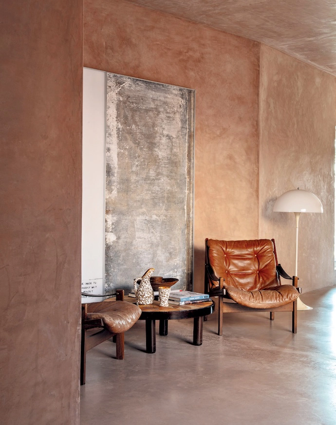 A reading area in the lounge features two 1960s Hunter armchairs by Torbjørn Afdal for Bruksbo and a Verner Panton lamp.