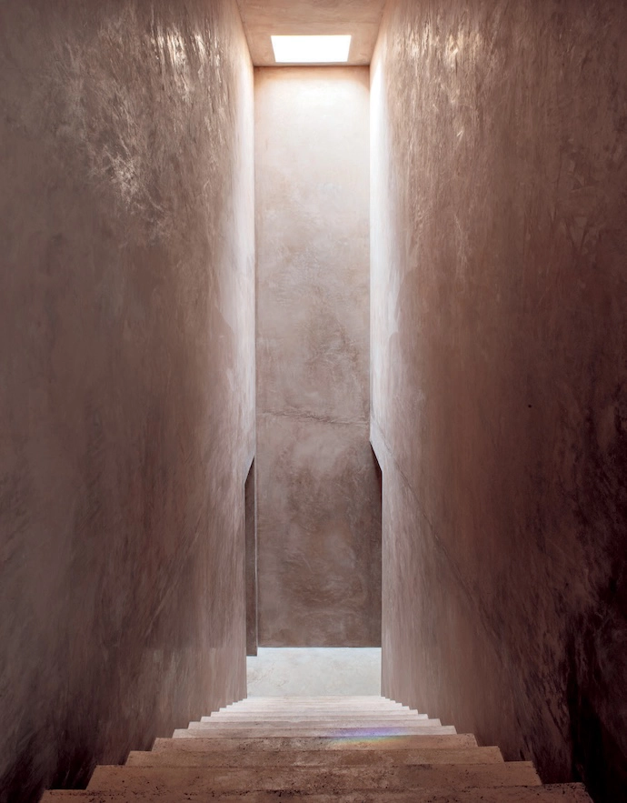  A staircase illuminated by a skylight leads to the bedrooms on the lower level.