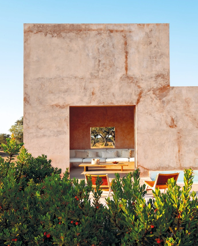 On either side of the vast living room, two outdoor terraces are shaded by an awning of eucalyptus branches to filter the sunlight.