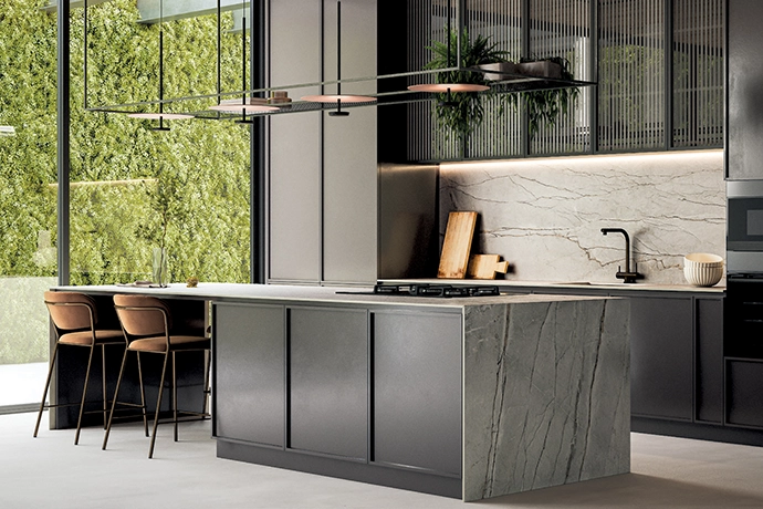 With their soft wood tones emphasised by the herringbone pattern, the Giornata Oro tiles by Ceramica add warmth and texture to the bold green-and-black palette of this modern kitchen, toning down the glossy cabinetry.