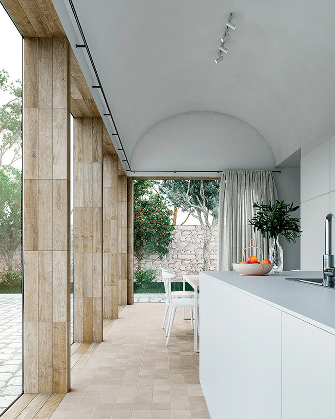 This idyllic kitchen with GEA Linen floors by Decobella opens up fully to connect to the exterior. 