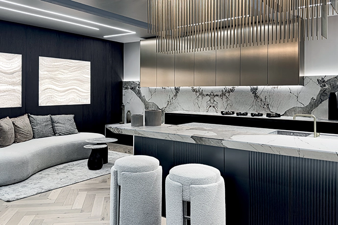 This sleek Nuuma design cleverly and unexpectedly incorporates a luxe sofa in the corner of the kitchen, its curves mimicking the counter seating and softening an otherwise linear aesthetic.