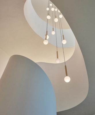 This lighting solution at Wave Villa (ARRCC) links the living spaces and serves as the “crown” of the home.