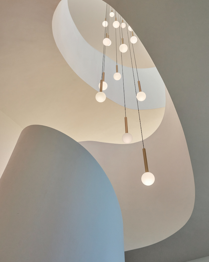 This lighting solution at Wave Villa (ARRCC) links the living spaces and serves as the “crown” of the home.