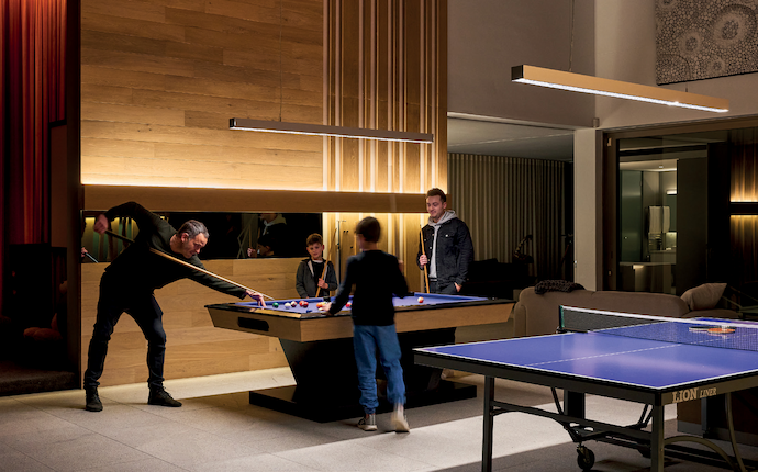 In the games room at Project Beyond, indirect ambient lighting accentuates the warmth of the 
timber, while task lighting ensures functionality.