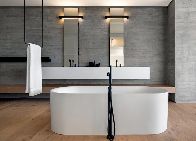 The lights beside the mirrors at OVD525 provide an indirect glow, accentuating the texture of the concrete walls.