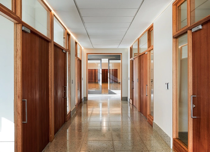 The internal doors and windows of the new oﬃces were chosen to integrate with the existing design language.