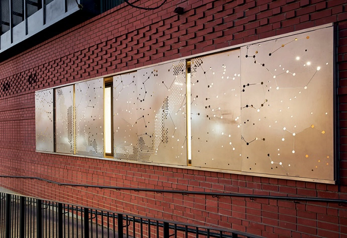 Sliding sun screens are patterned with constellations – a reference to the etchings in the glasswork above the entrance of the original building.
