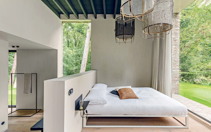 The master bedroom is warm but minimalist, with whites and creams as the predominant palette.