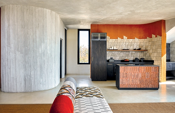 The texture of the curved wall was created by scraping lines into the RhinoGlide surface plaster. All joinery is by Cajaka.