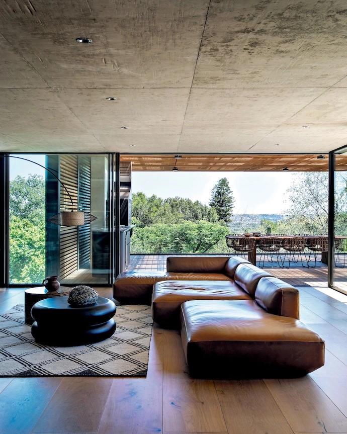 The main living area flows onto an outdoor bridge, leading to a floating patio that perfectly frames the panoramic views.