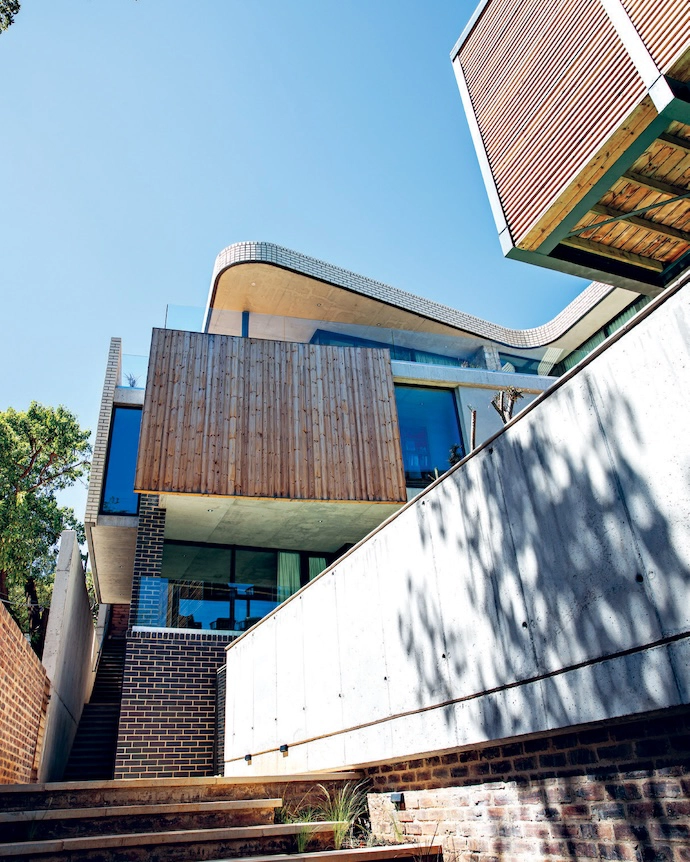 The home’s complex geometry is softened by a rich palette of materials.