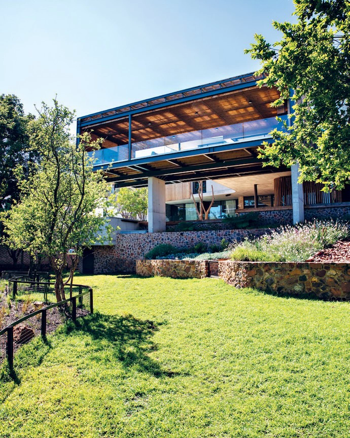 From the bottom of the steeply sloping site, the true elevation of the floating patio becomes apparent.