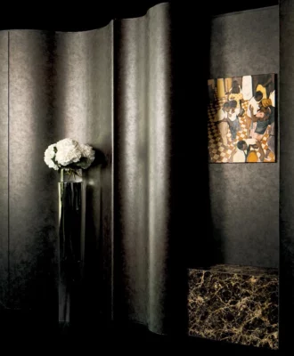 The foyer features curved joinery executed by St James Interiors and wrapped in a sculptural oxidised bronze finish.