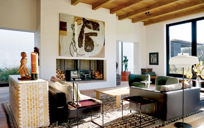 Filled with owners Nell and Kevin Harris’s collection of locally designed furniture and enviable art, the living room features Ligne Roset sofas, a server by Dokter and Misses, a Tube coffee table by Deft Studios, a Copenhagen floor lamp by &Tradition from Créma, and an artwork above the fireplace by Australian artist Peter Sharp.