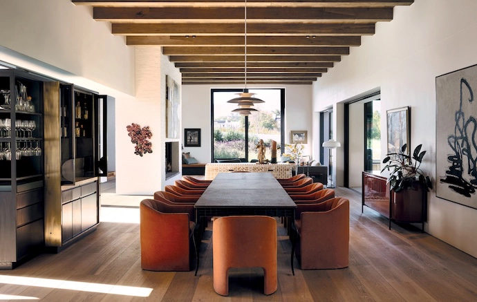 A 12-seater dining table by Gregor Jenkin is paired with Loafer dining chairs by &Tradition from Créma, a Mezzanine server and a PH5 pendant light by Louis Poulsen from Il Lusso, as well as a bespoke bar that was designed by VKDB Architects and built by Evelyn Terblanche from Versfeld.