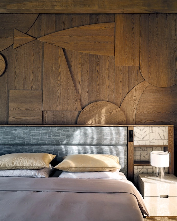 The main bathroom opens onto the same private terrace as the main bedroom. Wooden floors are a warm contrast against the dramatic Afristone slabs in the shower and on the vanity. The stone bathtub is by Bone Studio, and the fixtures are from Lavo Bathroom Concepts.