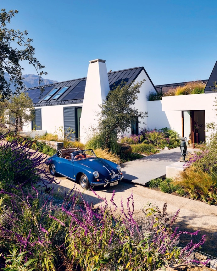 Designed in the style of a Cape langhuis, the home is a modern farmhouse. Two barns laid out over three levels are connected by courtyards and a rooftop terrace. By placing the house on the lowest contours of the site, architect Arn Erasmus ensured that the building feels grounded and that, with time, the landscaping will ground it further. In the courtyard that connects the entrance hall to the living area, a life-sized bronze-cast sculpture of a shepherd tree by artist Nic Bladen is a serious wow factor.