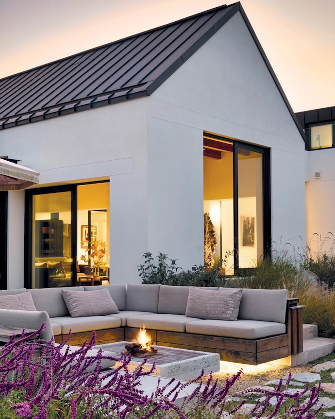 Designed in the style of a Cape langhuis, the home is a modern farmhouse. Two barns laid out over three levels are connected by courtyards and a rooftop terrace. By placing the house on the lowest contours of the site, architect Arn Erasmus ensured that the building feels grounded and that, with time, the landscaping will ground it further. In the courtyard that connects the entrance hall to the living area, a life-sized bronze-cast sculpture of a shepherd tree by artist Nic Bladen is a serious wow factor.