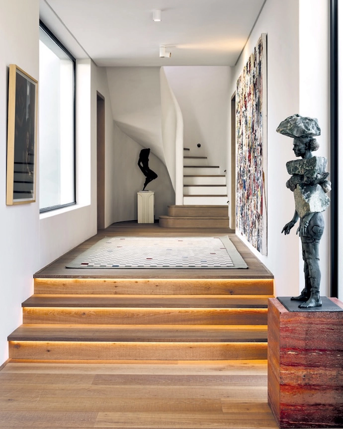 Designed in the style of a Cape langhuis, the home is a modern farmhouse. Two barns laid out over three levels are connected by courtyards and a rooftop terrace. By placing the house on the lowest contours of the site, architect Arn Erasmus ensured that the building feels grounded and that, with time, the landscaping will ground it further. In the courtyard that connects the entrance hall to the living area, a life-sized bronze-cast sculpture of a shepherd tree by artist Nic Bladen is a serious wow factor.