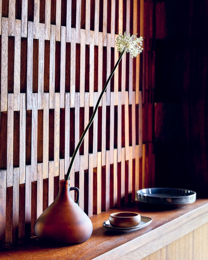 The exquisite brise-soleil section of the wall that separates the kitchen from the living space.