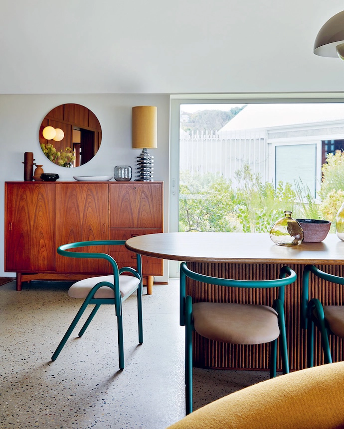 The dining space features one of the home’s many picture windows.
