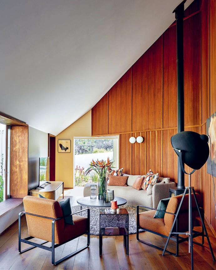 The tranquil, private TV lounge that doubles as a working space for Nina stays cosy in winter thanks to a wood-burning stove by Charnwood.