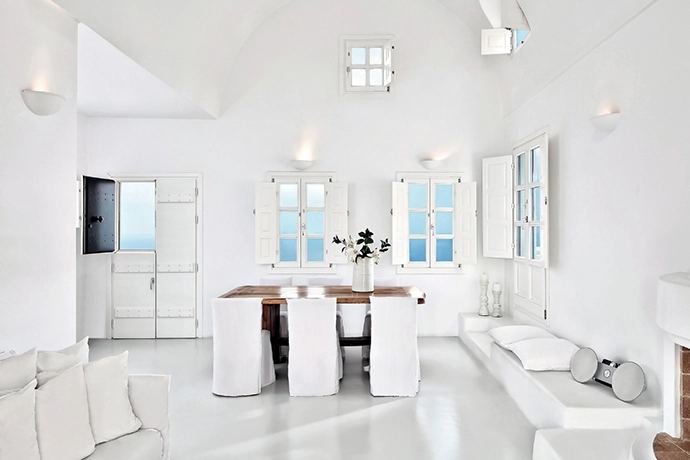 Dressed in Cyclades white, each villa features smooth yet layered interiors, with a pared-back contemporary aesthetic that references traditional elements of sun- bleached wood and quarried stone.
