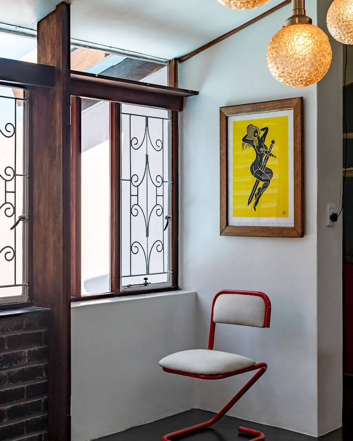 Quiet drama in the entrance lobby, featuring a Flying Dagger print by Marchand and a Marcel Breuer-style chair.