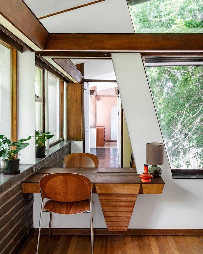 Following the diagonal line of the window frame, the built-in vanity is a true one-off.