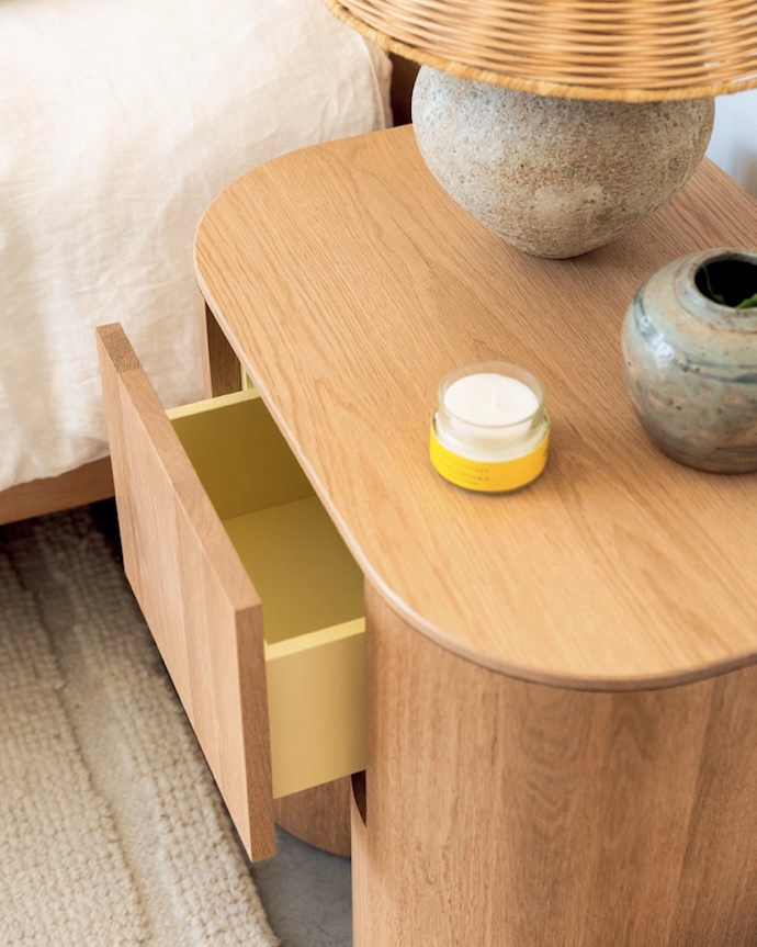 Bedside table with a pop of buttery yellow.