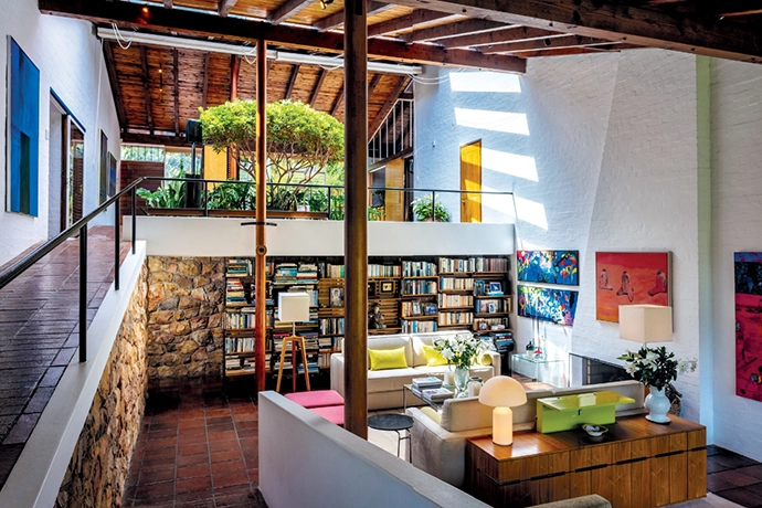 The double-volume living area includes a bespoke bookcase/room divider designed by Gawie. Behind it is the passage to the guest bedroom and bathroom. The room is the ideal space to show off some of owner Lana Hudson’s art collection, which includes works by Clive van den Berg and Robert Hodgins.