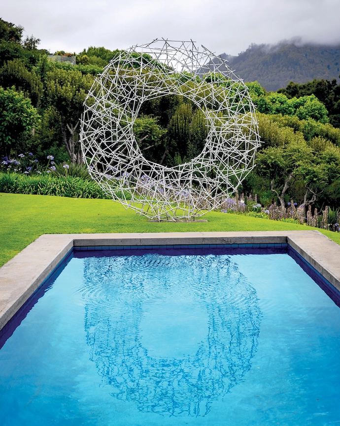 Reflected in the pool is a Strijdom van der Merwe sculpture.