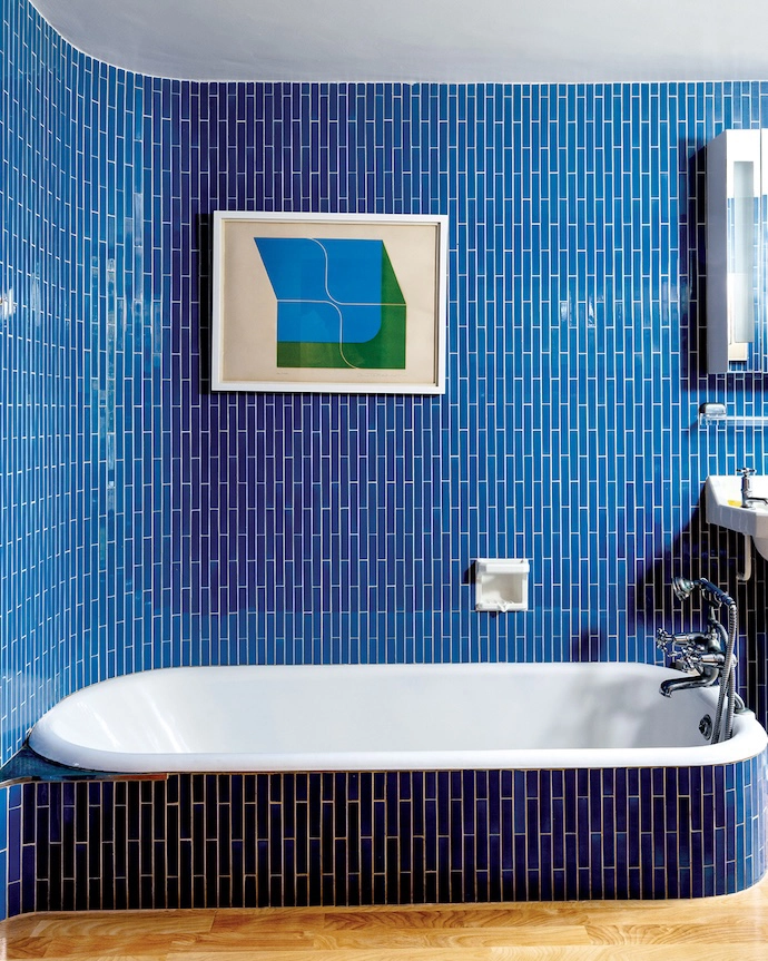 The curved-walled guest bathroom still has original fittings, including this beautiful tilework.