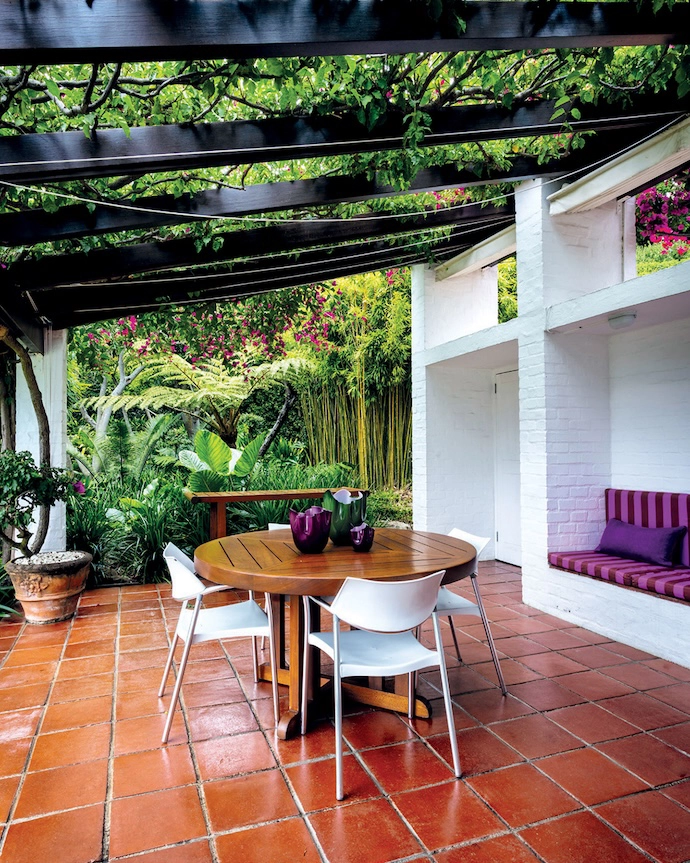 The sunroom opens onto a shaded courtyard – both have expansive mountain views.