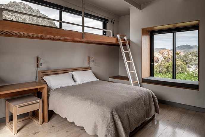 The “family” bedroom boasts bunk beds for the kids, as well as a desk and built-in storage.