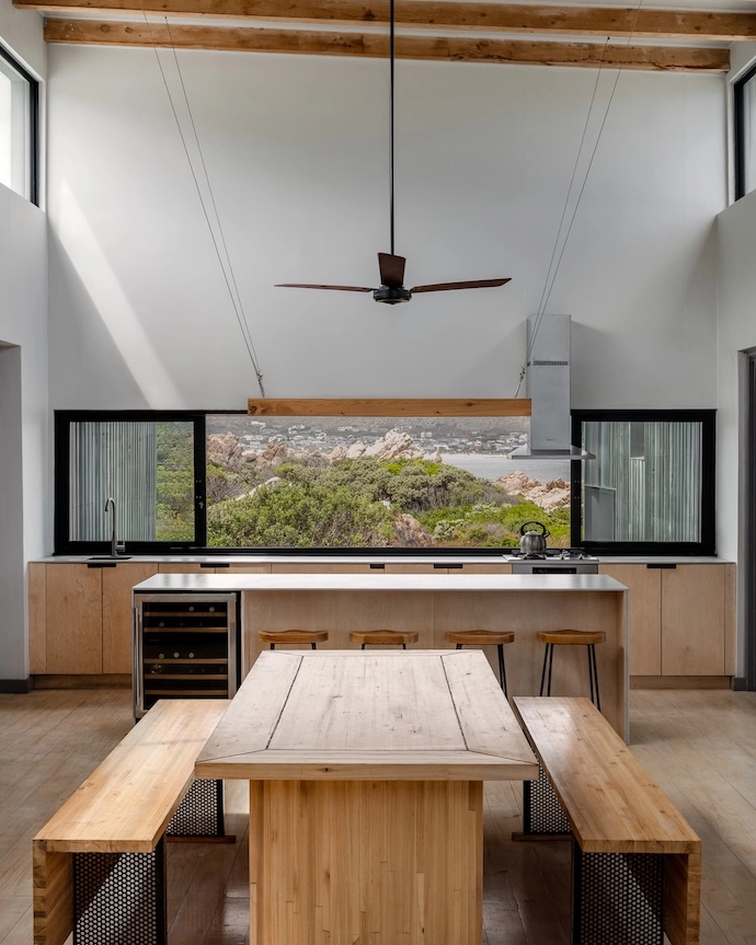 The owner designed the uncluttered interior, which is characterised by wood accents such as the cabinetry, and a dining table built by her father.