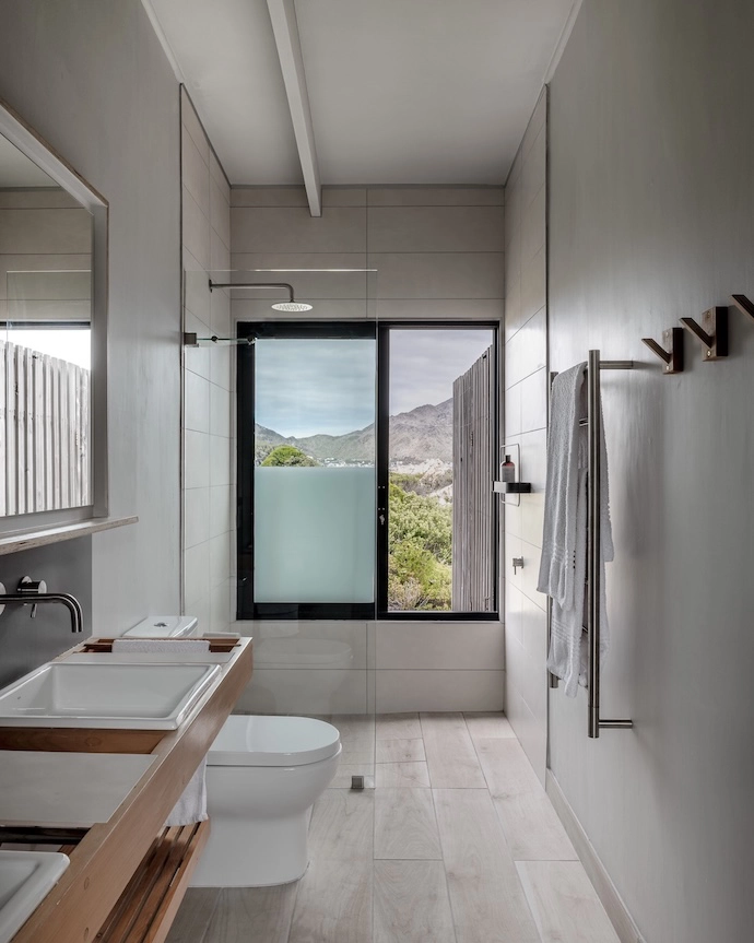 The bathroom (with a view!) features a double vanity designed by the owner.