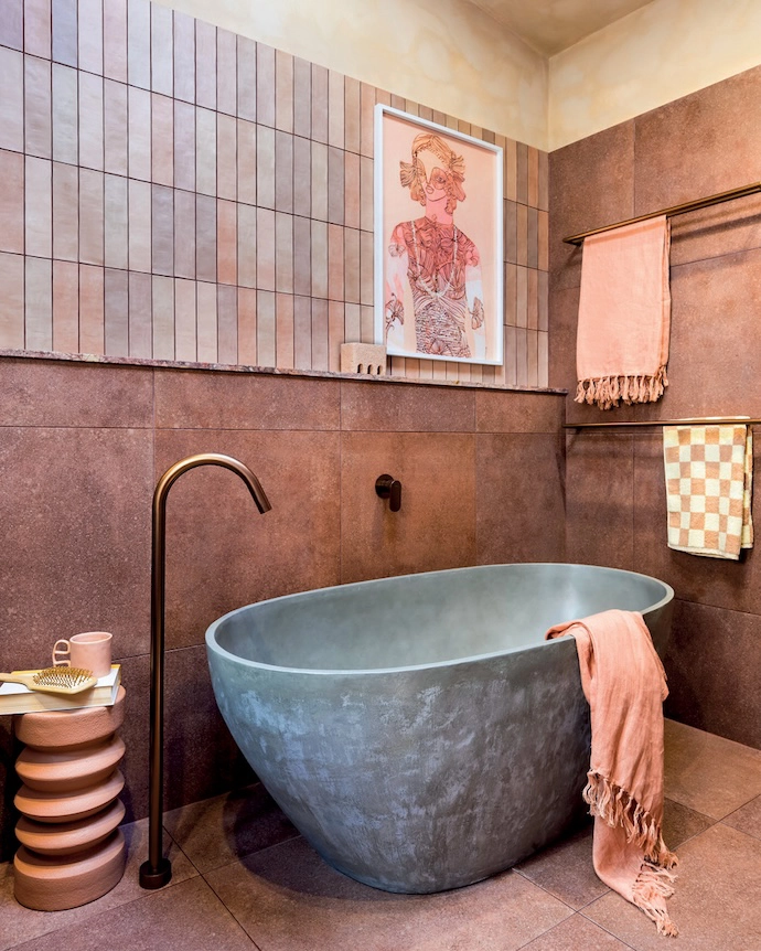The grey colour of this freestanding bathtub makes it a point of focus in Australian interior stylist Tim Neve’s tone- on-tone bathroom. “It’s the textures that really enliven this space, introducing a comforting and earthy ambience,” he explains. “Adding matt bronze tapware makes it even more luxurious.”