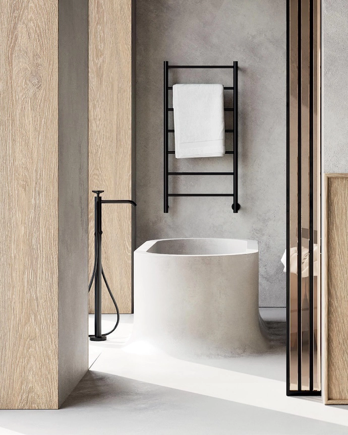 Black fixtures, including a Spartan F heated towel rail by Jeeves, pair well with concrete for a Zen-like industrial look. The material used for the flooring is sculpted into a bath, its curved lines introducing softness to an otherwise austere space. For a similar effect, contact Cemcrete about the brand’s RenoCrete.