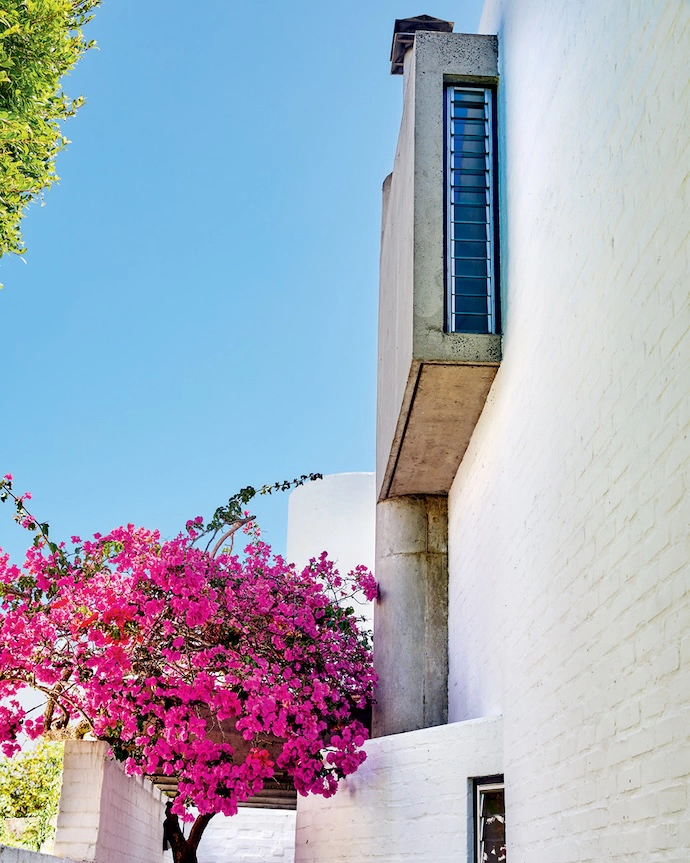 The vertical slit window extends the sightline of the hallway.