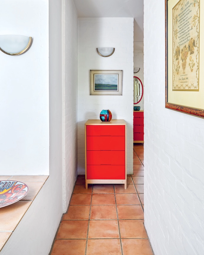 Pops of red and royal blue abound, including a Pedersen + Lennard chest of drawers and an accent pillar.