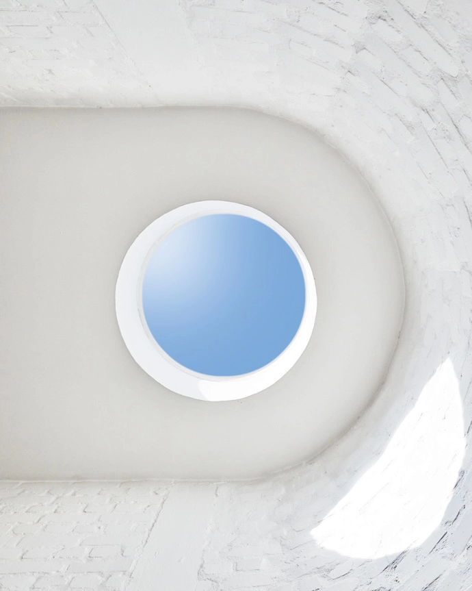 A skylight floods the space with sun, playing up the texture of the bagged brick walls and encouraging upward glances.
