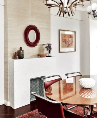 On the mantelpiece, a Neil Bradford ceramic vase is flanked by a Moroccan terracotta vase and bowl.