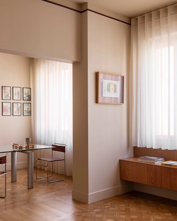A view of the dining room from the living area featuring Libellula chairs, designed by Giovanni Carini for Planula, and curtains in FISCHBACHER fabric 113/117/132.