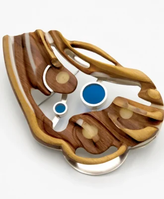 Siboneni (See Us) brooch (2022) in Jelutong, resin and silver by Dr Bongani TP Mashange.