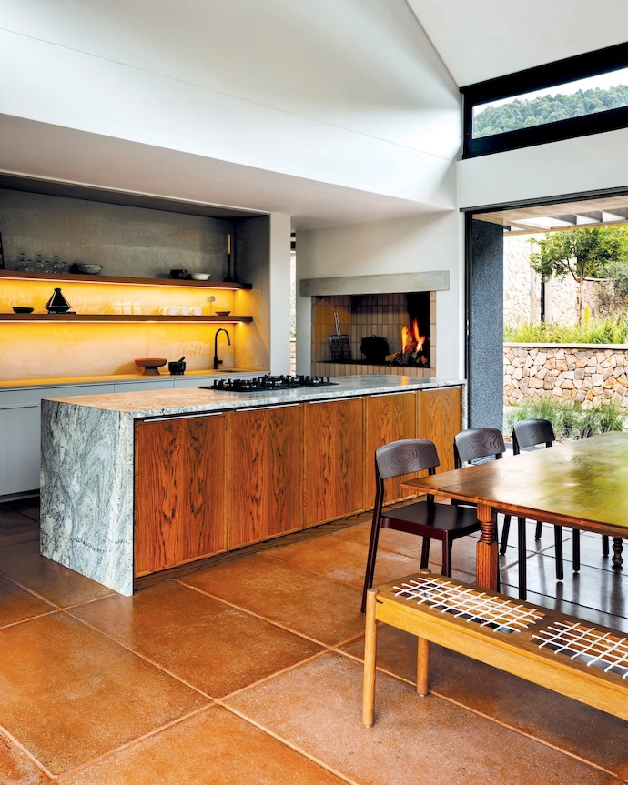 The kitchen includes a braai area, for those rainy Mpumalanga days. The large handmade pavers introduce warmth, texture and a touch of imperfection to the interiors.